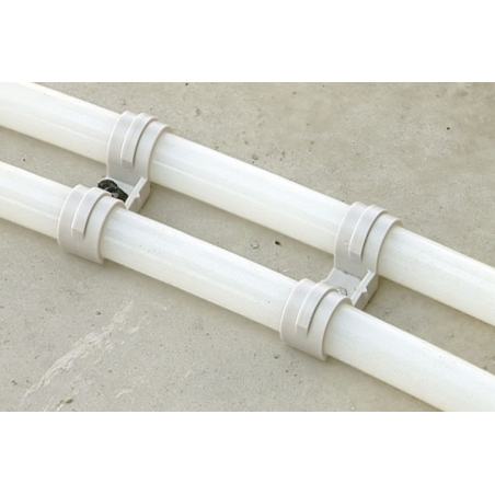 Application image of condiut clip FPD: Two plastic pipes mounted on concrete with FPD